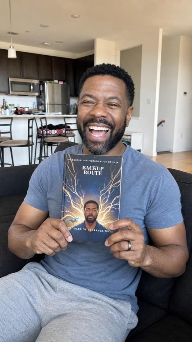 A man laughing as he holds up his personalized novel, his portrait on the cover